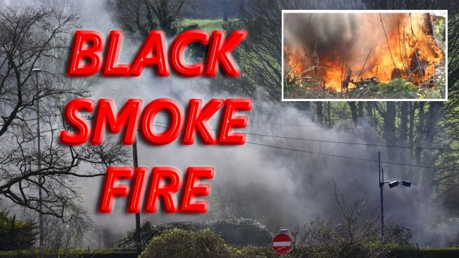 Fire Spouts Black Smoke onto busy road - pollution police